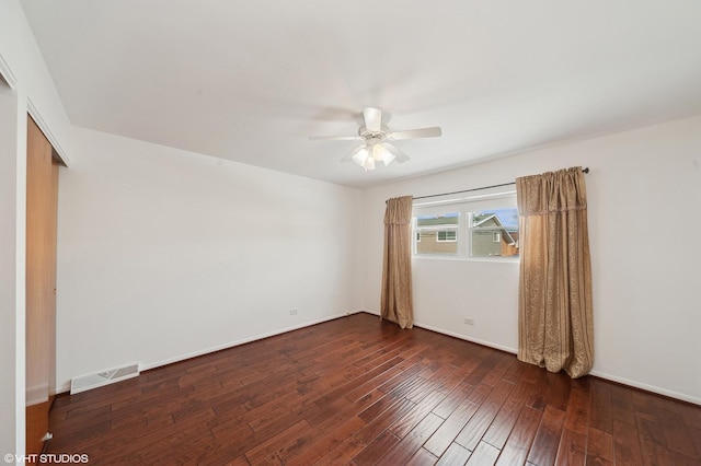 spare room featuring ceiling fan and dark hardwood / wood-style floors