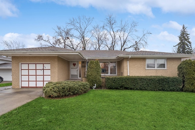 view of front of property featuring a garage and a front lawn