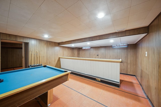 recreation room featuring wood walls