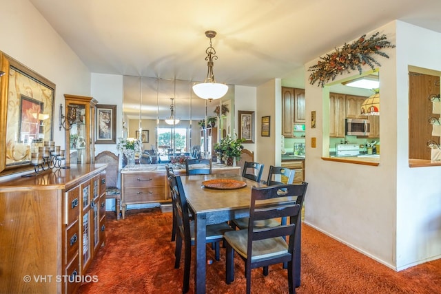 view of carpeted dining area