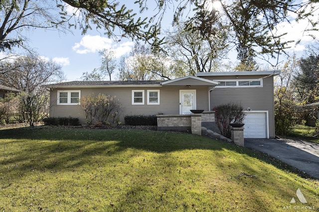 single story home with a garage and a front lawn