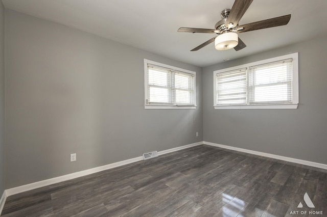 empty room with dark wood-type flooring and ceiling fan