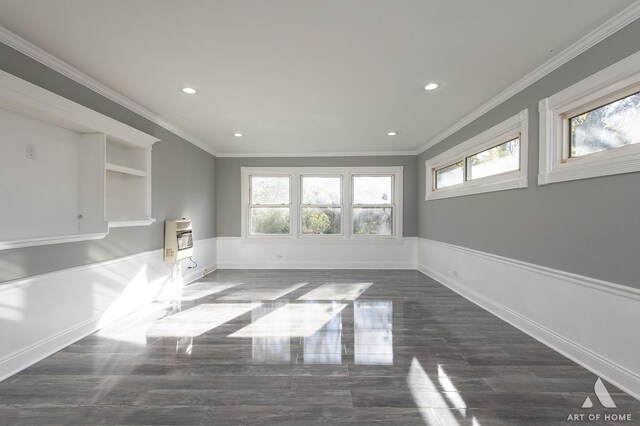 spare room with crown molding and heating unit