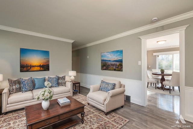 living room with crown molding and wood-type flooring