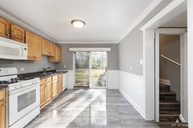 kitchen featuring crown molding, white appliances, and sink