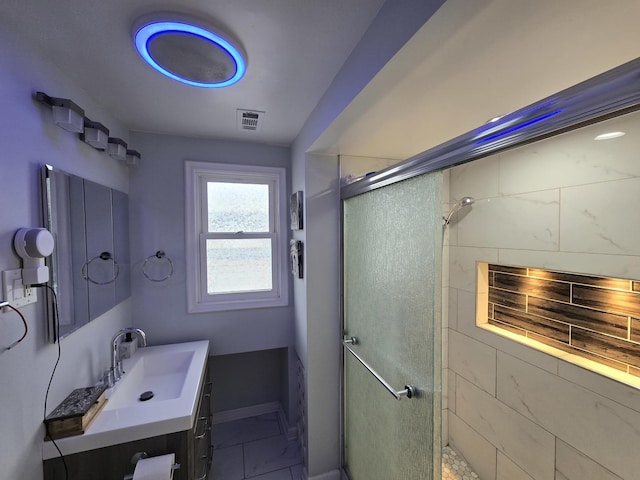 bathroom with vanity and a shower with door