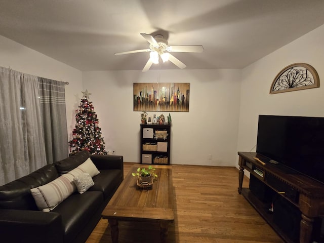 living room featuring hardwood / wood-style floors and ceiling fan