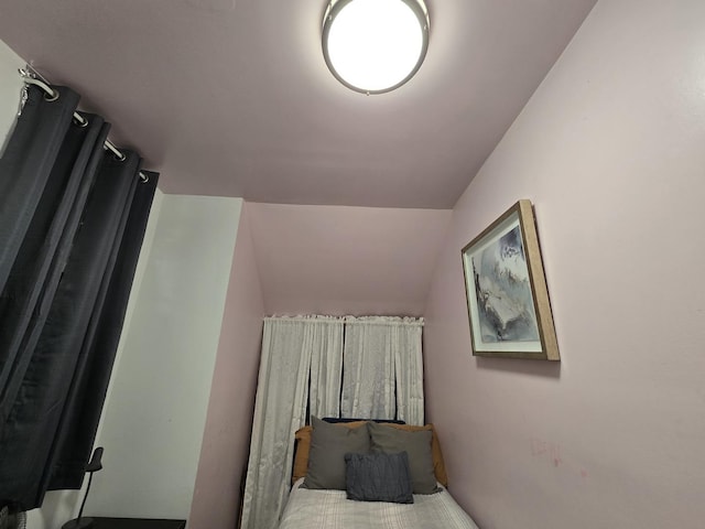 unfurnished bedroom with lofted ceiling