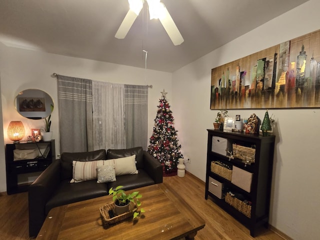 living room featuring hardwood / wood-style floors and ceiling fan