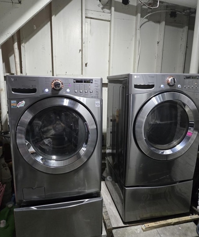 laundry area with washing machine and dryer