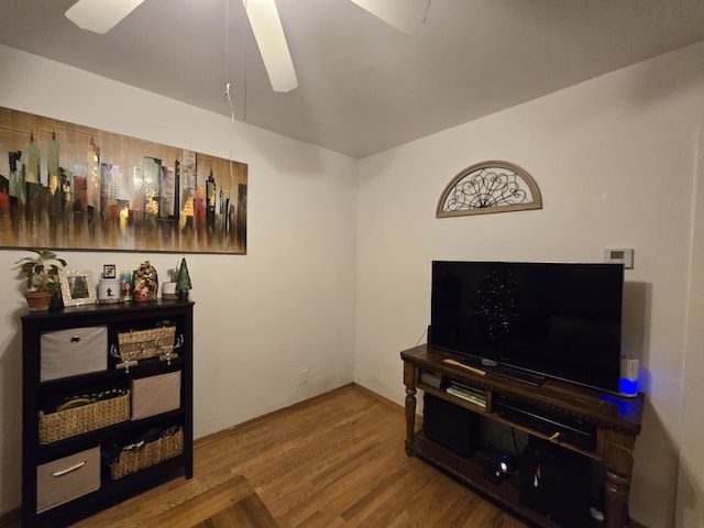 living room featuring ceiling fan and hardwood / wood-style floors