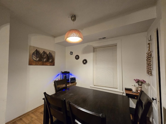 dining space with hardwood / wood-style flooring