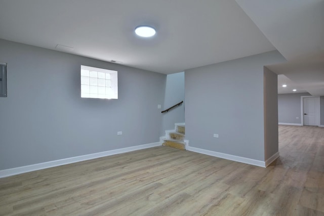 basement with light hardwood / wood-style floors