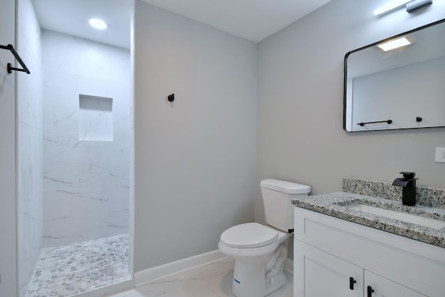 bathroom featuring vanity, toilet, and a shower