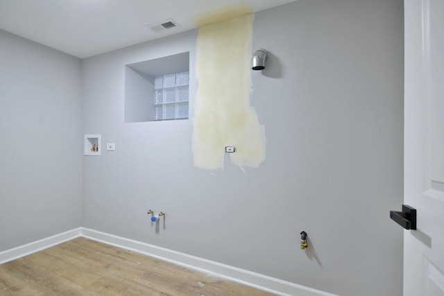 washroom featuring hardwood / wood-style flooring and washer hookup