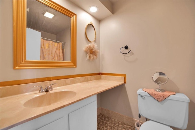 bathroom with vanity, toilet, and tile patterned flooring