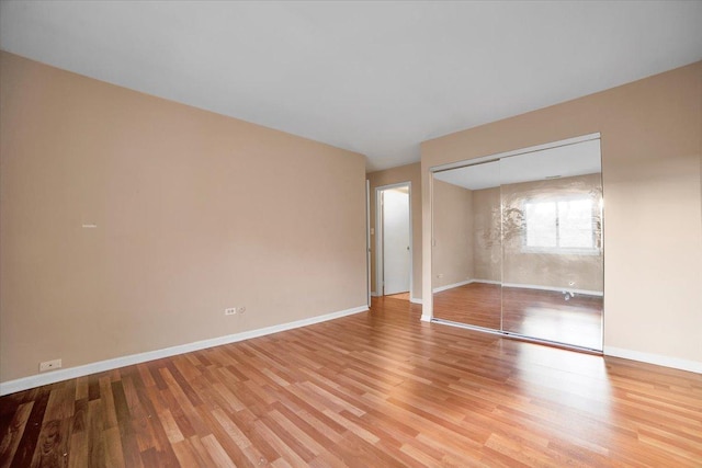 spare room with hardwood / wood-style floors