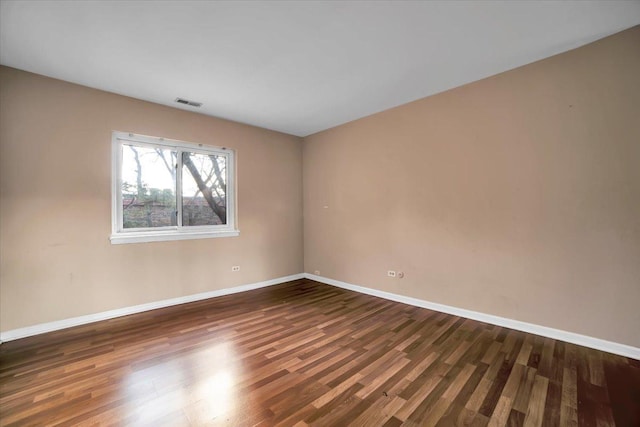 unfurnished room featuring dark wood-type flooring