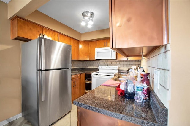 kitchen with white appliances and decorative backsplash