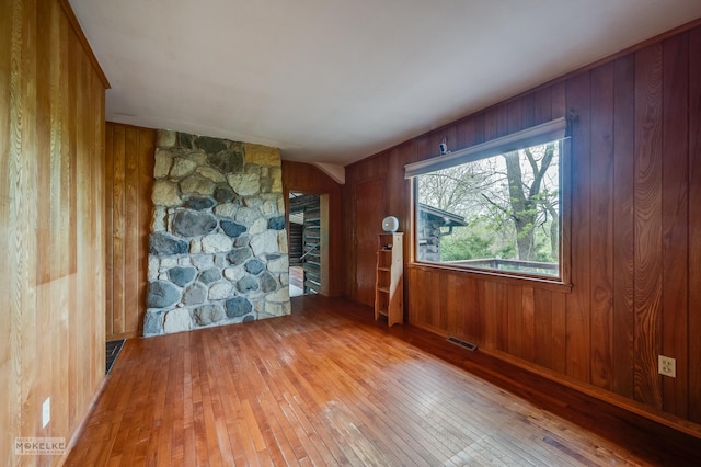 1026 State Route 25, Oswego, IL 60543 - empty room featuring wood walls, hardwood / wood-style floors, and visible vents