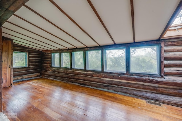 1026 State Route 25, Oswego, IL 60543 - spare room with visible vents, log walls, lofted ceiling, and hardwood / wood-style floors