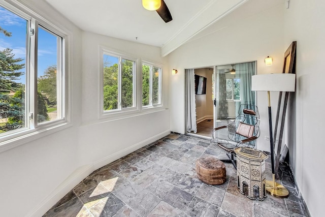 sunroom / solarium with ceiling fan and vaulted ceiling