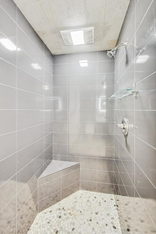 bathroom with a tile shower