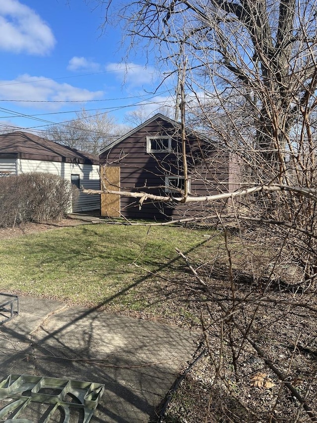 view of outbuilding with a yard