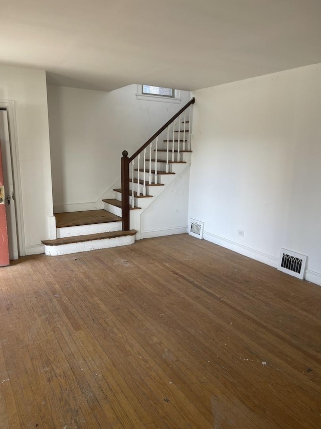 unfurnished living room featuring hardwood / wood-style floors