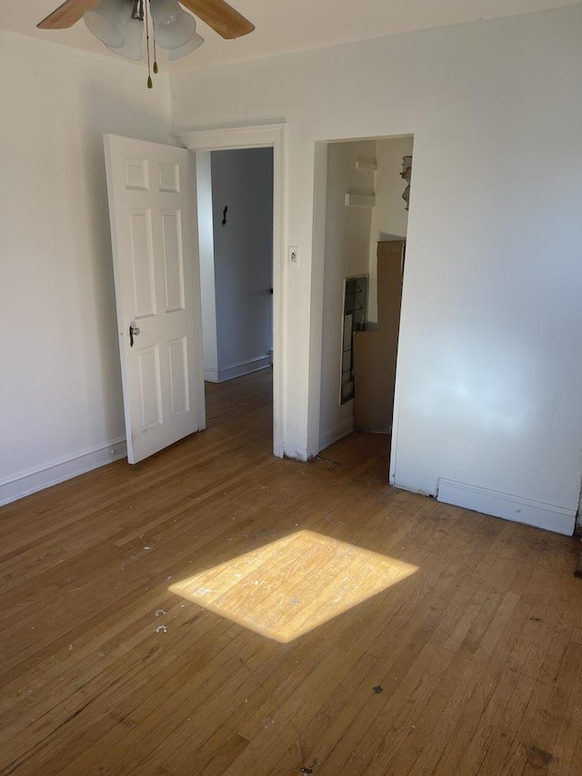 unfurnished room featuring hardwood / wood-style flooring and ceiling fan