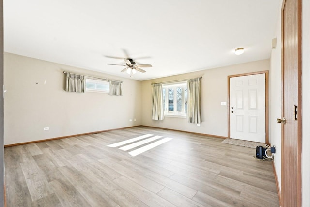 empty room featuring ceiling fan and light hardwood / wood-style flooring