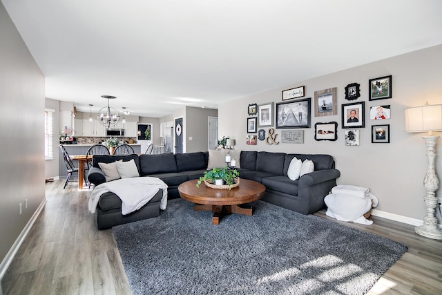 living room featuring hardwood / wood-style floors and a chandelier