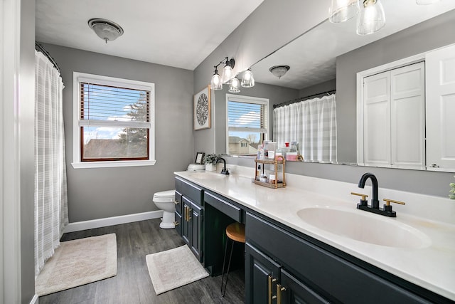 bathroom featuring vanity, hardwood / wood-style flooring, and toilet