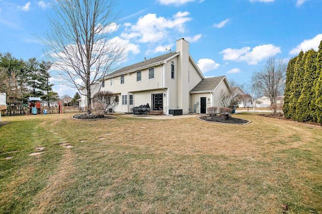 rear view of house with central AC, a yard, a playground, and a patio area