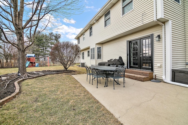 view of patio featuring central AC unit, french doors, and a playground