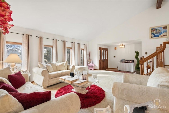 living room featuring an inviting chandelier and high vaulted ceiling