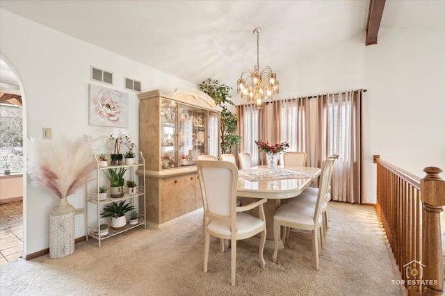 carpeted dining room featuring lofted ceiling with beams and a notable chandelier