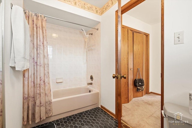 bathroom featuring shower / bath combination with curtain and toilet