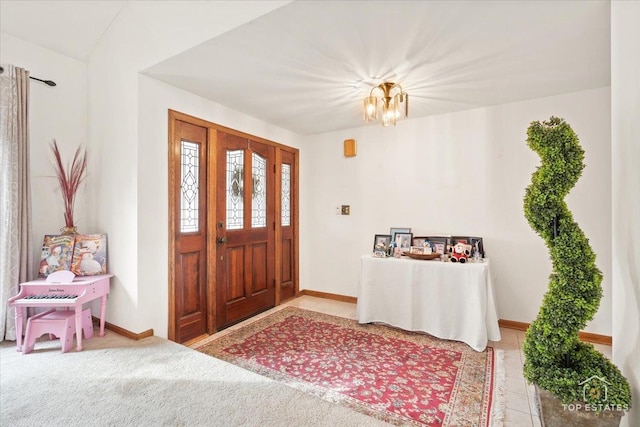 carpeted entryway with a chandelier