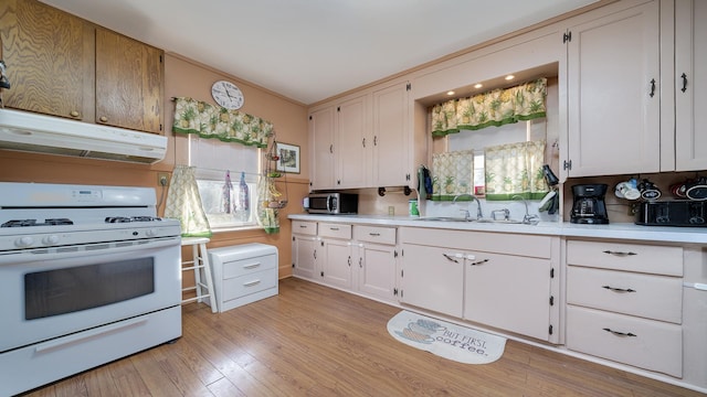 kitchen featuring white cabinetry, white range with gas cooktop, sink, and light hardwood / wood-style flooring