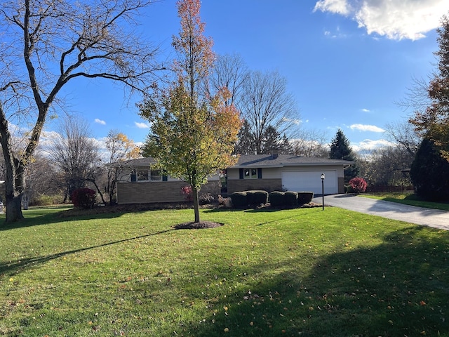 view of front of house with a garage and a front yard