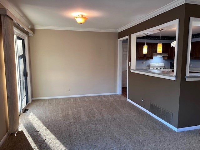 unfurnished room with light carpet and crown molding