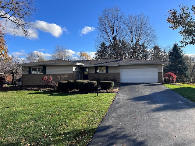 single story home featuring a garage and a front yard