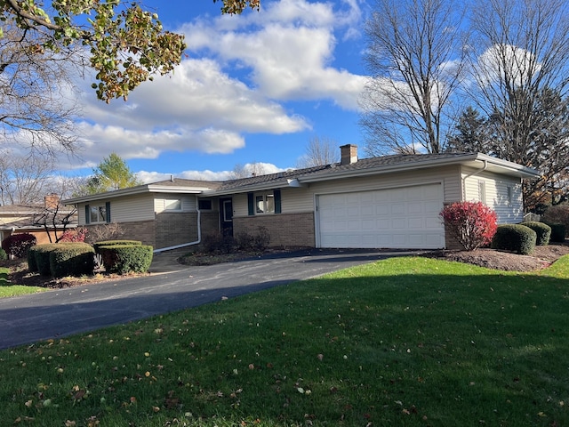 ranch-style house with a garage and a front lawn