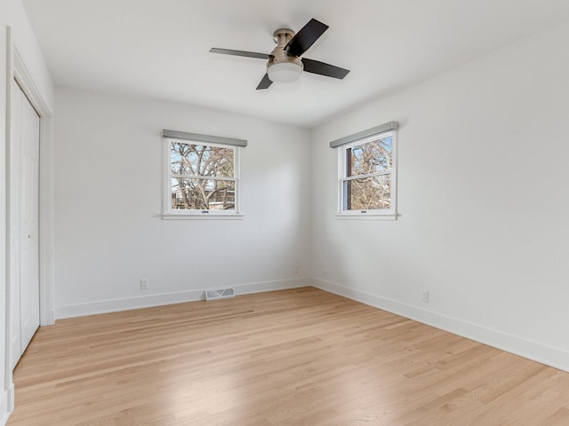 unfurnished bedroom featuring ceiling fan, light wood-type flooring, and a closet