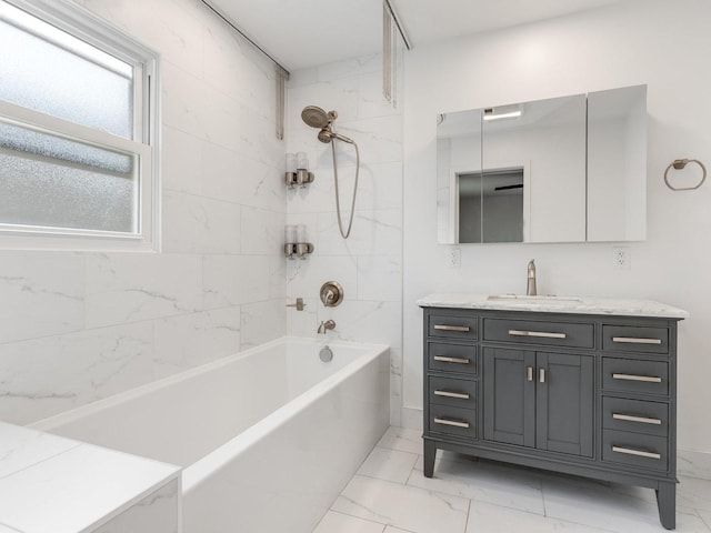 bathroom with vanity and tiled shower / bath combo