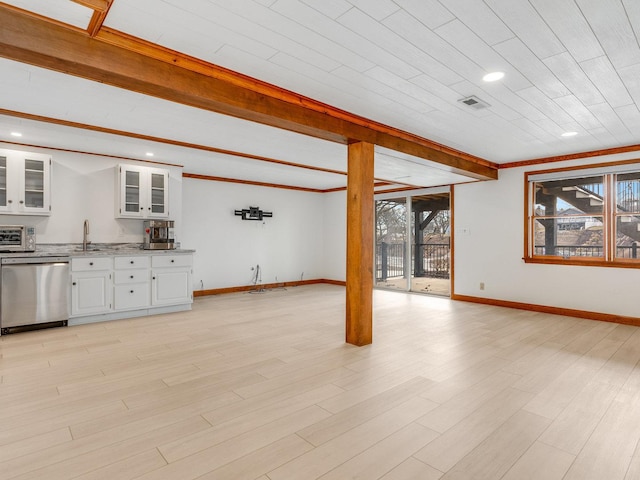 unfurnished living room featuring beamed ceiling, sink, and light hardwood / wood-style flooring