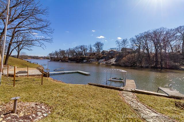 dock area with a yard and a water view