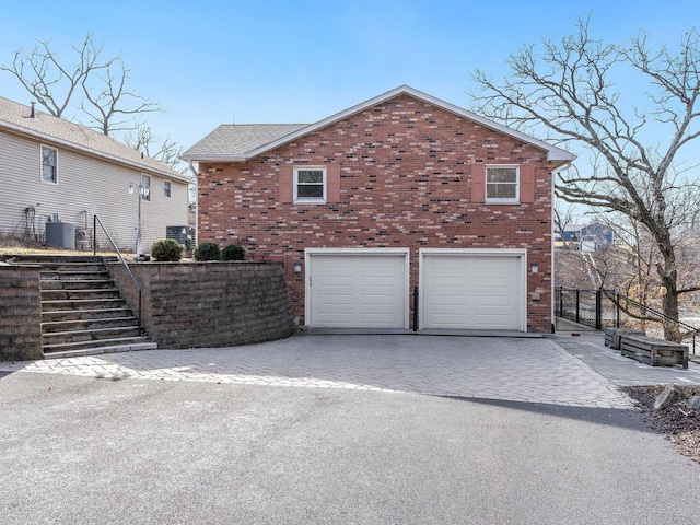 view of home's exterior featuring a garage and central air condition unit