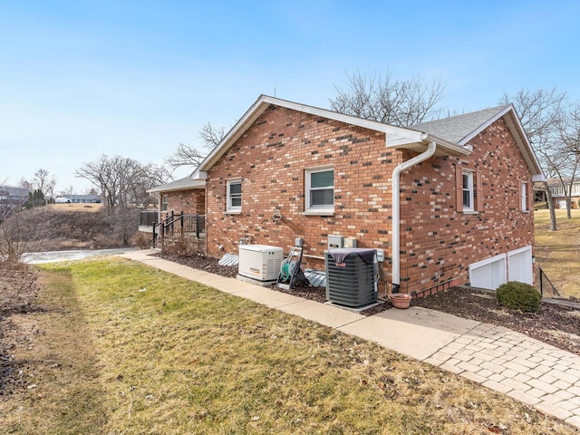 view of property exterior featuring central AC unit and a lawn